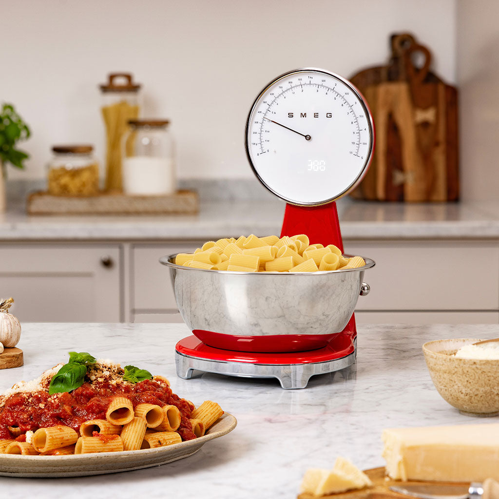 SMEG kitchen scale with a bowl of pasta on a kitchen counter