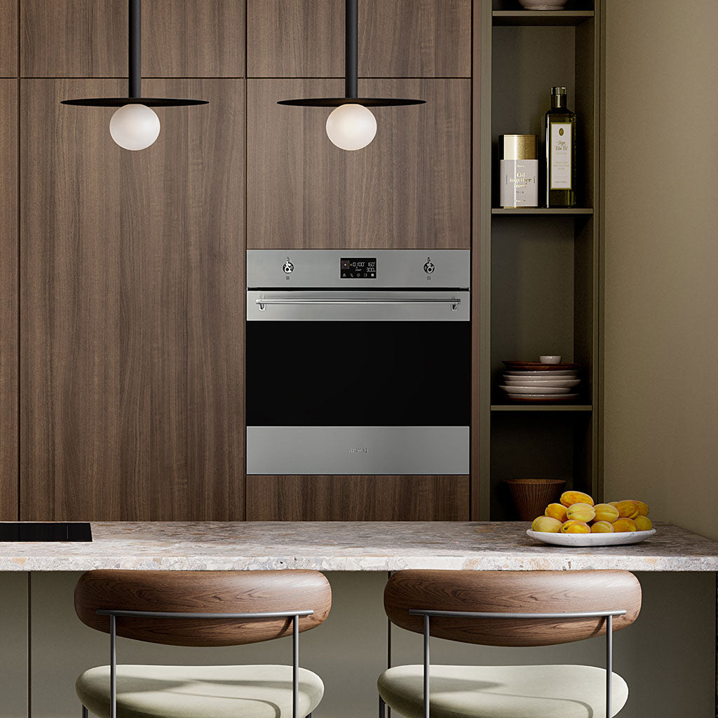 Modern kitchen with wooden cabinets, a Smeg stainless steel oven, and a marble countertop.